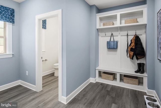 mudroom featuring dark wood-style floors and baseboards