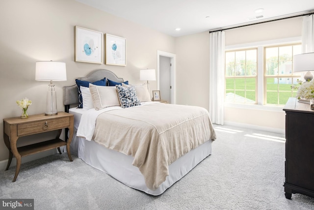 bedroom with visible vents, recessed lighting, light colored carpet, and baseboards