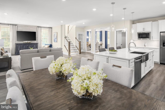 kitchen with a healthy amount of sunlight, stainless steel appliances, and dark wood-style flooring