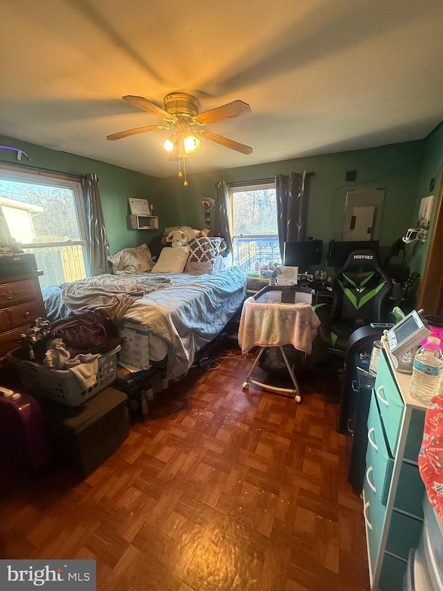 bedroom featuring multiple windows and a ceiling fan