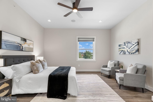 bedroom featuring a ceiling fan, recessed lighting, wood finished floors, and baseboards