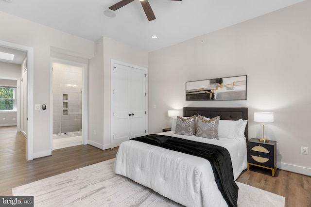 bedroom featuring a ceiling fan, wood finished floors, recessed lighting, a closet, and baseboards