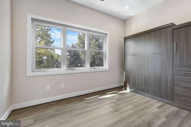 unfurnished bedroom featuring recessed lighting, baseboards, and light wood-style flooring