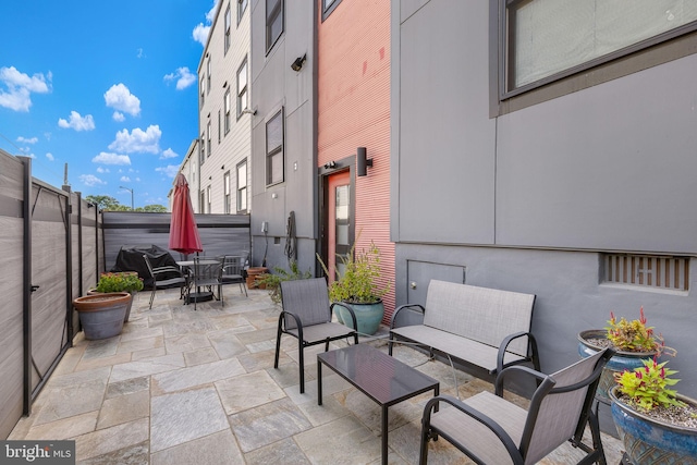 view of patio with outdoor dining space, outdoor lounge area, and a fenced backyard