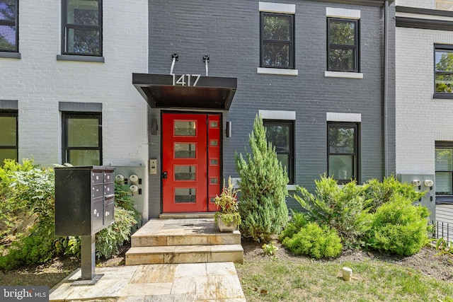 entrance to property featuring brick siding