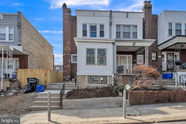 multi unit property featuring fence and a chimney