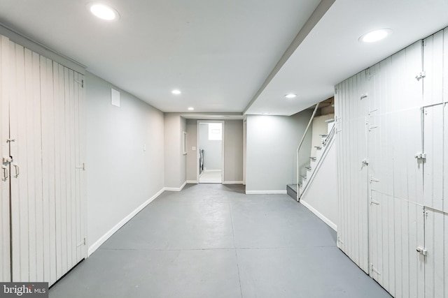 below grade area with recessed lighting, baseboards, and stairs