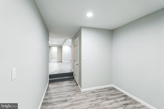 hallway with recessed lighting, baseboards, and wood finished floors