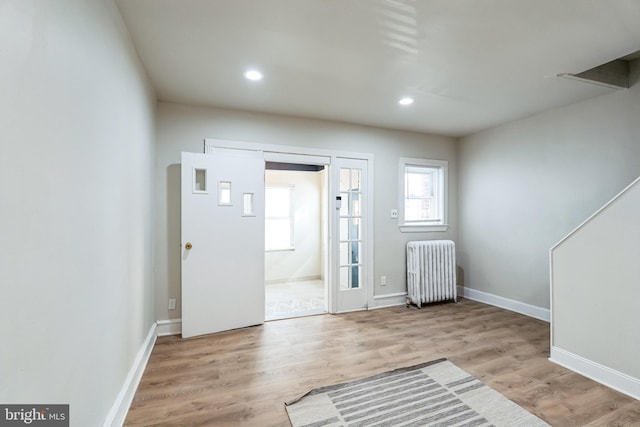 entryway featuring recessed lighting, radiator, wood finished floors, and baseboards