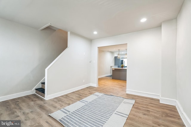 interior space featuring recessed lighting, wood finished floors, and baseboards