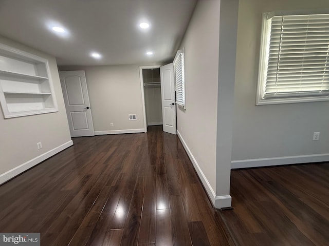 interior space with dark wood-type flooring, recessed lighting, and baseboards