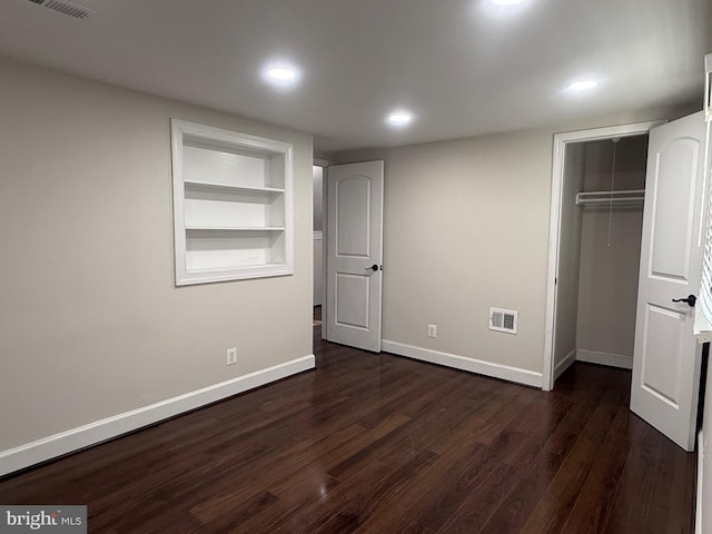 unfurnished bedroom with visible vents, dark wood finished floors, recessed lighting, a closet, and baseboards