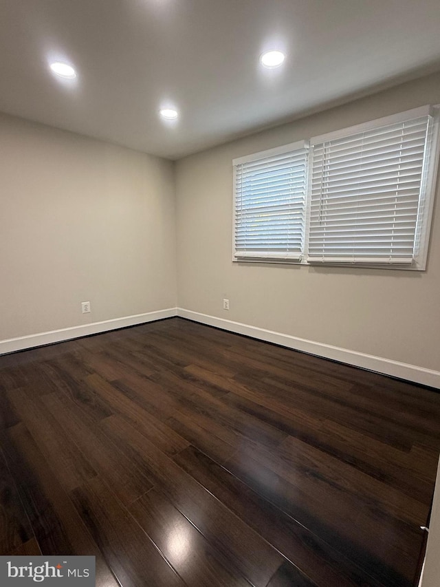 unfurnished room with recessed lighting, baseboards, and dark wood-style flooring