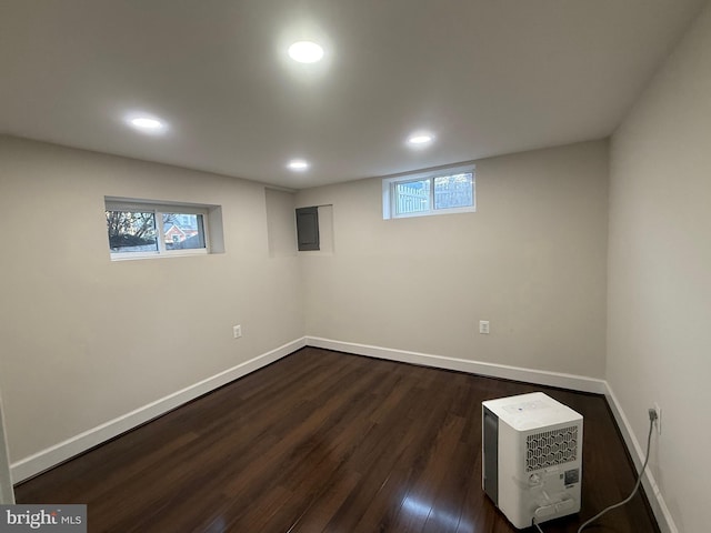 basement featuring recessed lighting, baseboards, and dark wood finished floors