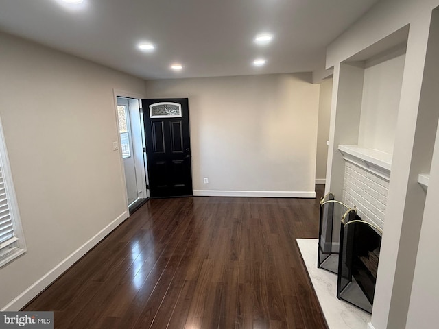 unfurnished living room featuring recessed lighting, baseboards, and wood finished floors