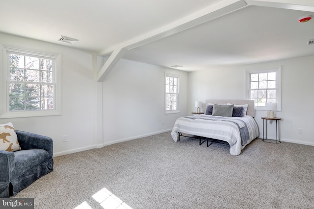 carpeted bedroom featuring visible vents, multiple windows, and baseboards