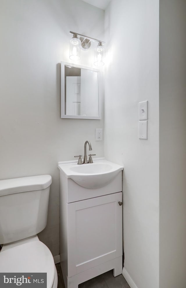 bathroom featuring toilet and vanity