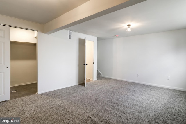 interior space featuring carpet flooring, baseboards, and visible vents