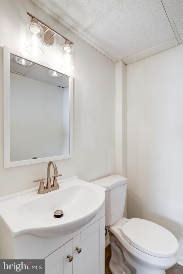 half bathroom featuring toilet and vanity