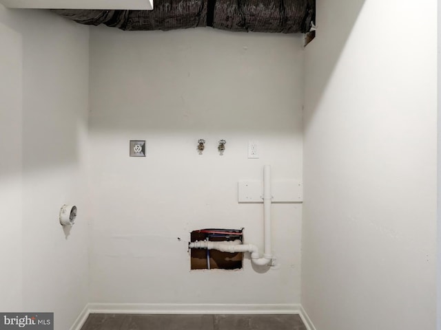 clothes washing area with hookup for a washing machine, baseboards, and laundry area