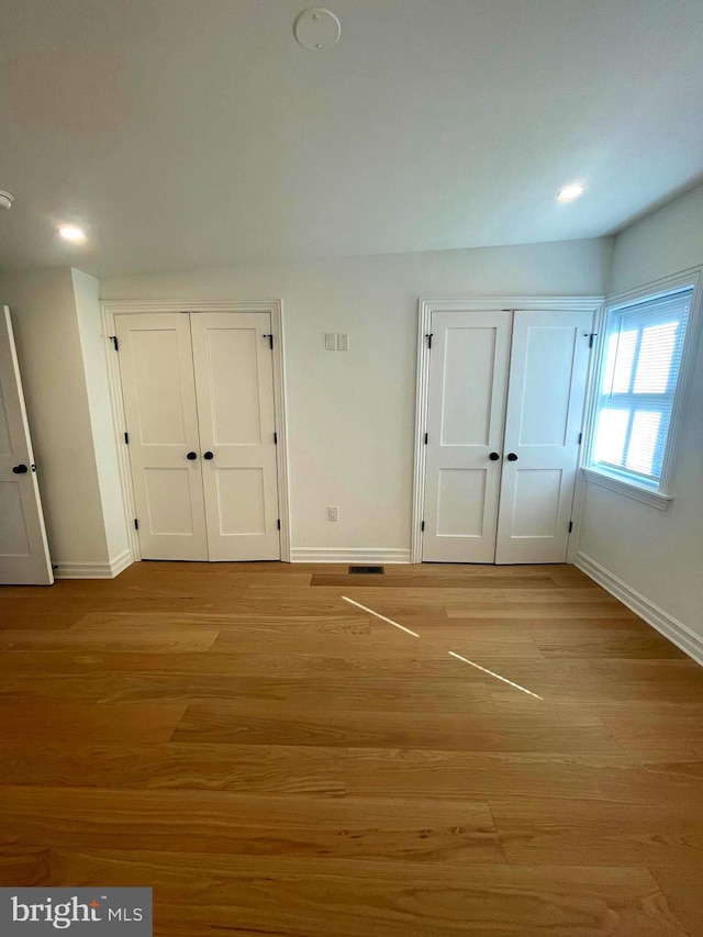 unfurnished bedroom featuring recessed lighting, baseboards, and light wood-type flooring