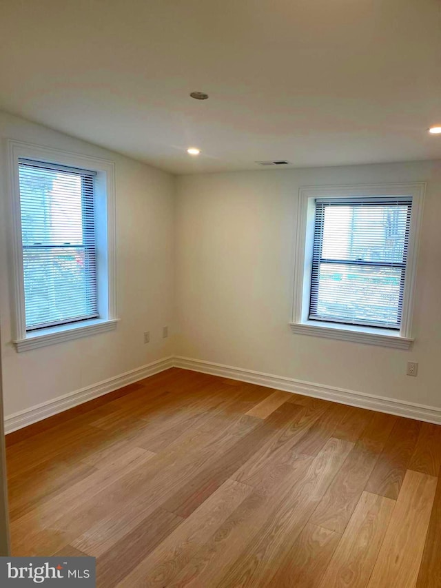 spare room featuring recessed lighting, visible vents, baseboards, and light wood-style floors