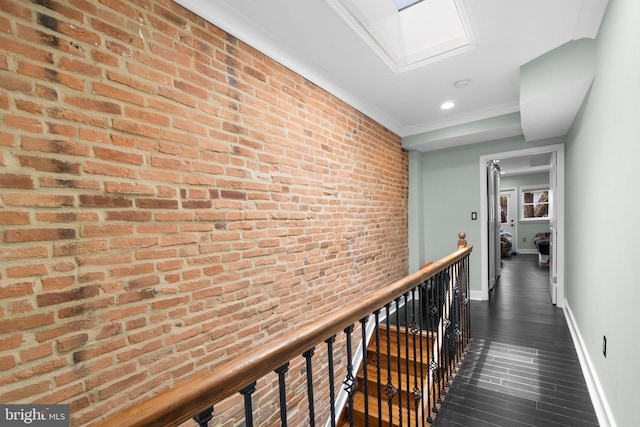 444 Grindall St, Baltimore, MD 21230 - corridor with baseboards, dark wood-type flooring, brick wall, and recessed lighting