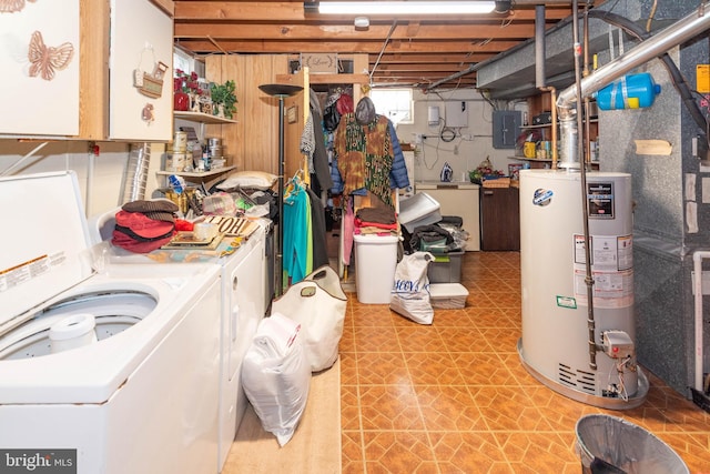 basement featuring water heater, washing machine and dryer, and electric panel