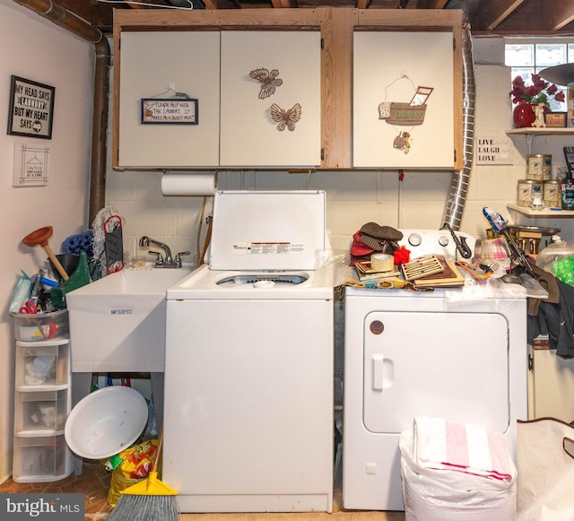 laundry room with a sink, laundry area, and washer and clothes dryer