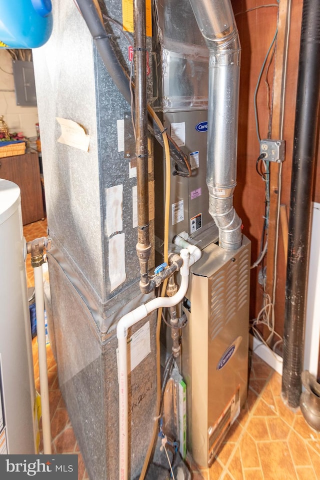 utility room featuring electric panel, heating unit, and water heater