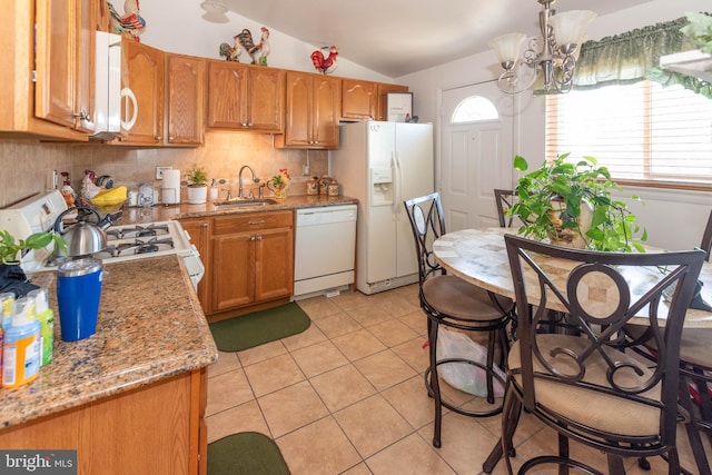 kitchen featuring white appliances, lofted ceiling, light tile patterned flooring, a sink, and backsplash