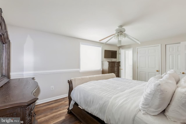 bedroom with ceiling fan, baseboards, and wood finished floors