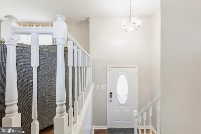 foyer entrance featuring a notable chandelier and stairs