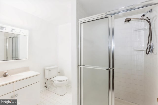 bathroom featuring vanity, toilet, and a shower stall