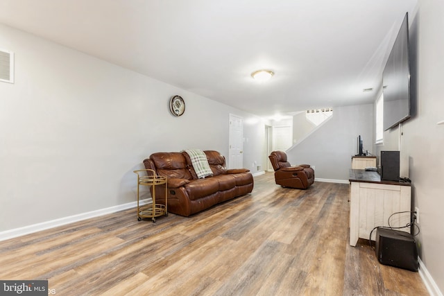 living room featuring baseboards and light wood-style floors