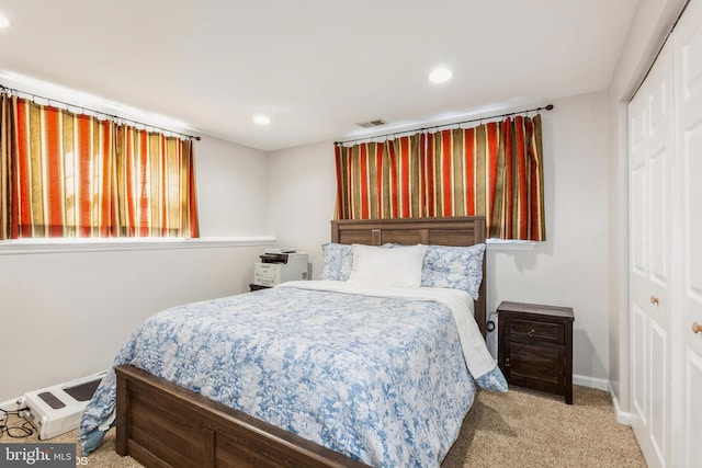 carpeted bedroom with recessed lighting, visible vents, a closet, and baseboards