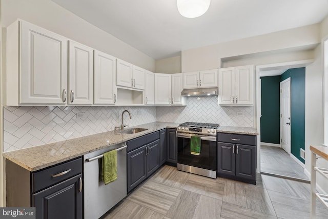 kitchen featuring a sink, appliances with stainless steel finishes, white cabinets, and under cabinet range hood