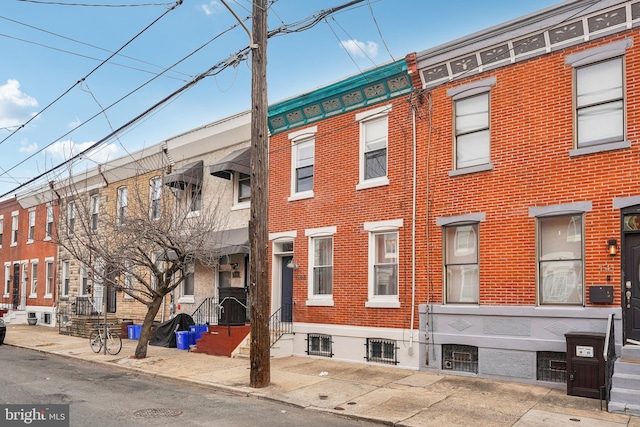 townhome / multi-family property featuring brick siding