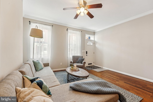 living room with ceiling fan, baseboards, wood finished floors, and ornamental molding