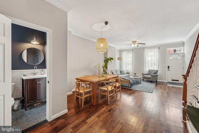 dining space featuring baseboards, a ceiling fan, dark wood-style flooring, and ornamental molding