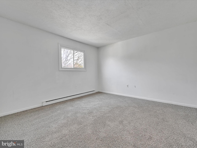 carpeted empty room with baseboards, baseboard heating, and a textured ceiling