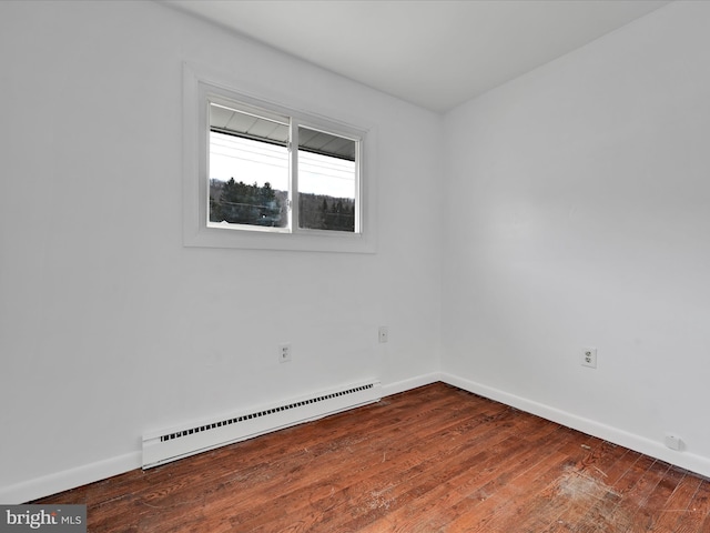 unfurnished room featuring hardwood / wood-style floors, baseboards, and a baseboard radiator