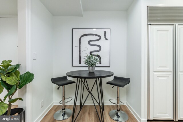 dining room featuring wood finished floors and baseboards