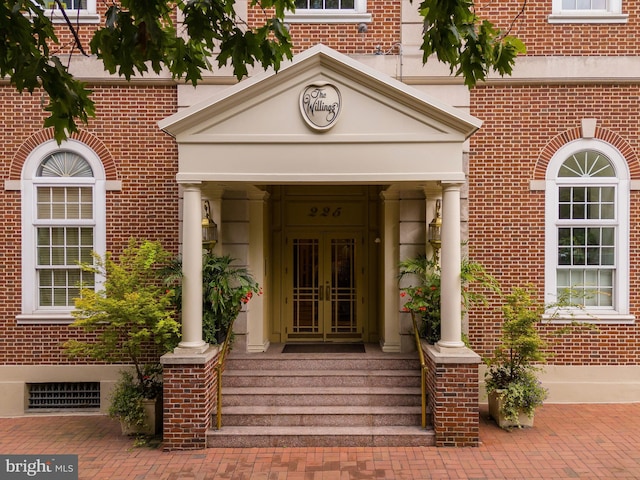 entrance to property with french doors and brick siding