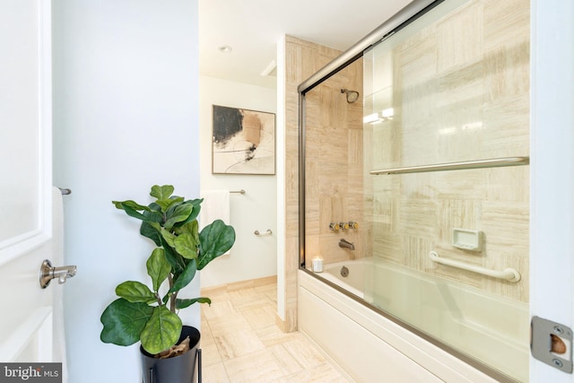 bathroom with shower / bath combination with glass door