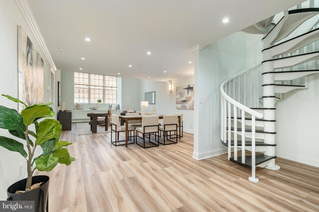 interior space featuring recessed lighting, baseboards, light wood-style flooring, and stairs