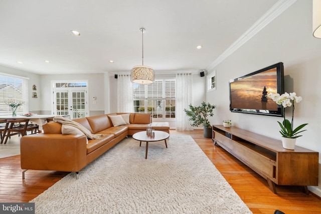 living area featuring recessed lighting, light wood-style flooring, and ornamental molding