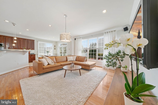 living area featuring recessed lighting, a healthy amount of sunlight, and light wood finished floors