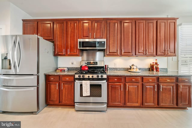 kitchen featuring stone counters and appliances with stainless steel finishes