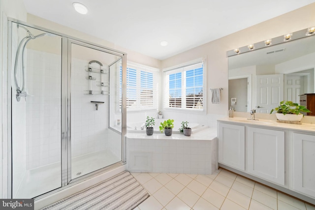 bathroom featuring vanity, visible vents, tile patterned flooring, a shower stall, and a garden tub